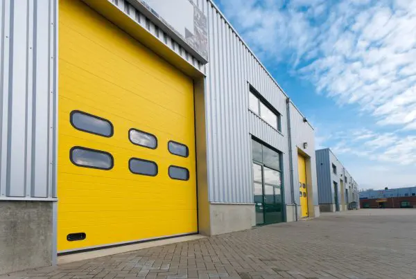 Industrial warehouse with green and yellow roller doors