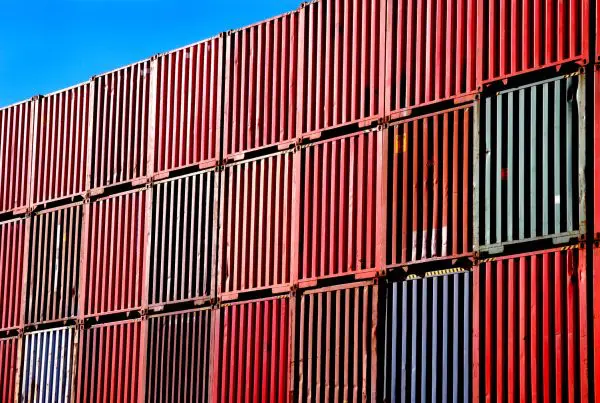 tacked shipping container. A picture of shipping containers, stacked up high in a port.