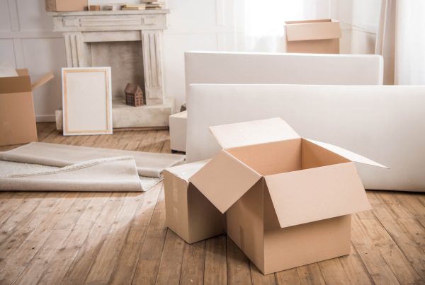 cardboard boxes and furniture in empty room